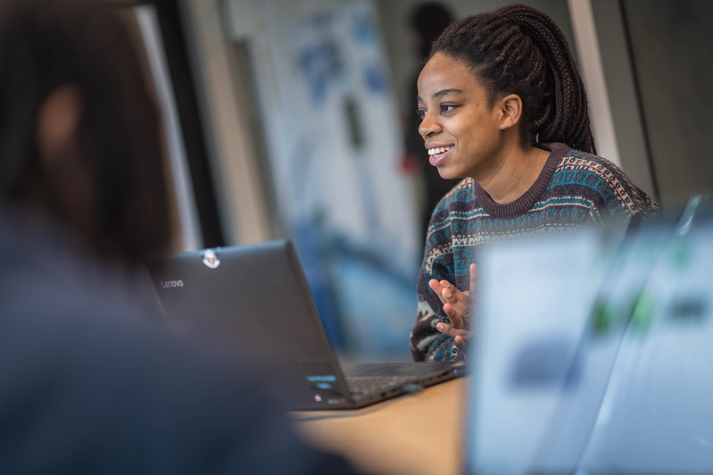 Woman smiling while using laptop