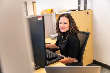 A staff working on her computer.