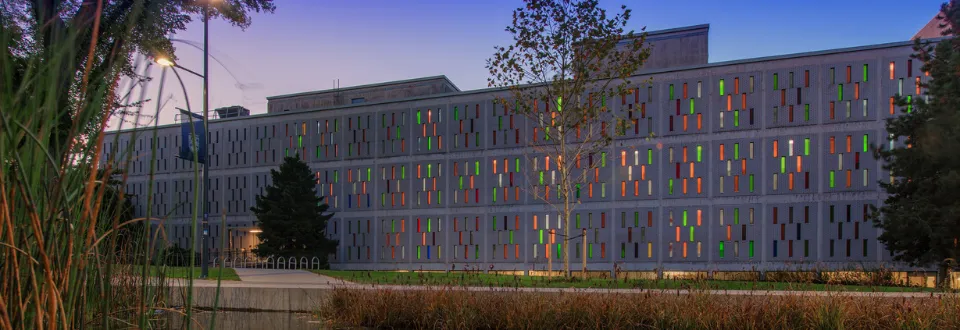 UBC campus building at dusk, featuring colorful vertical windows.