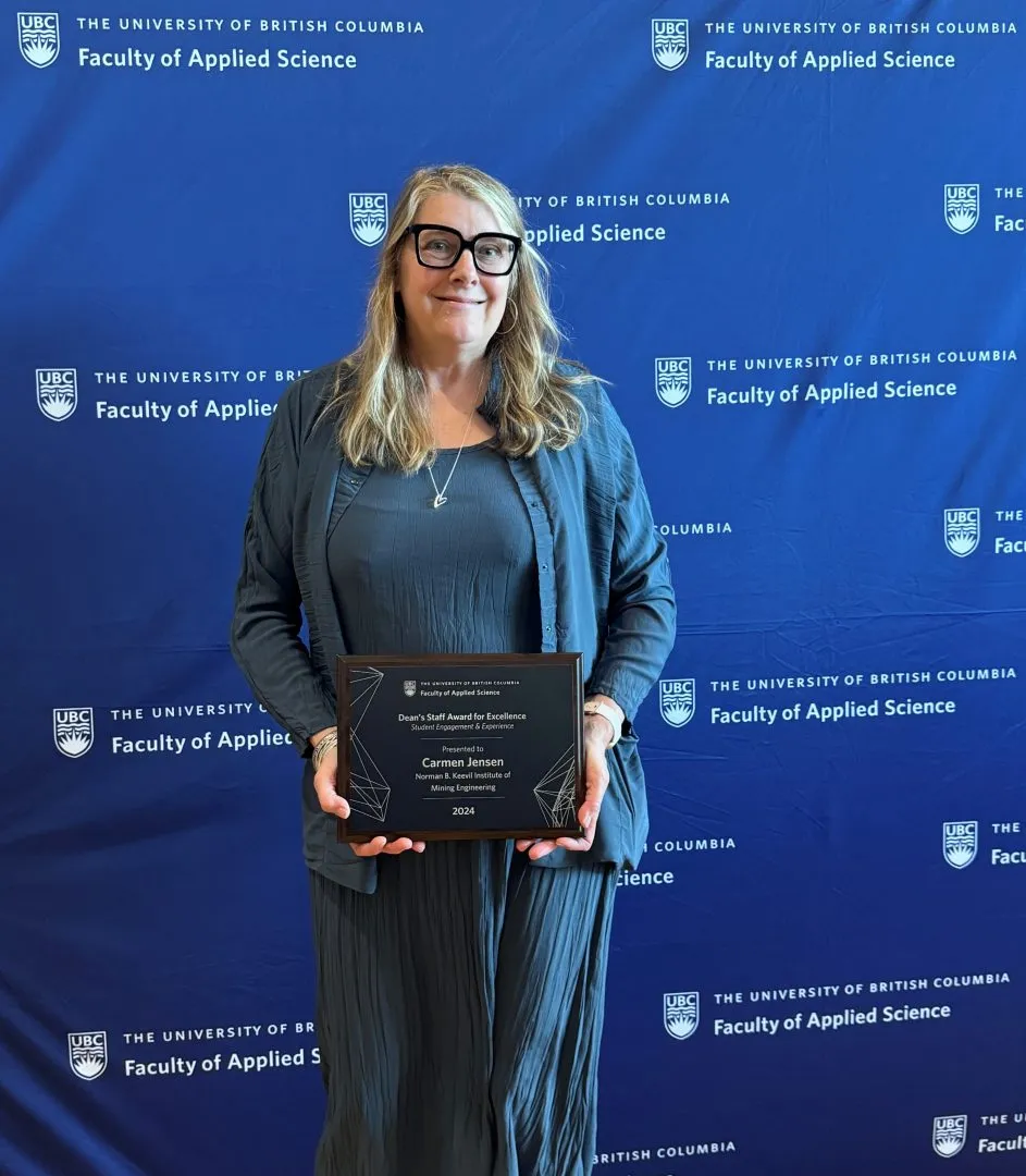 Carmen smiling holding certificate